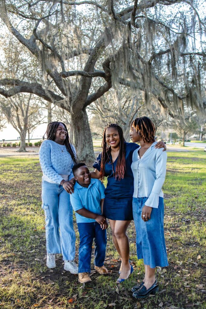 Family in blue under spanish moss in Mandeville louisiana
