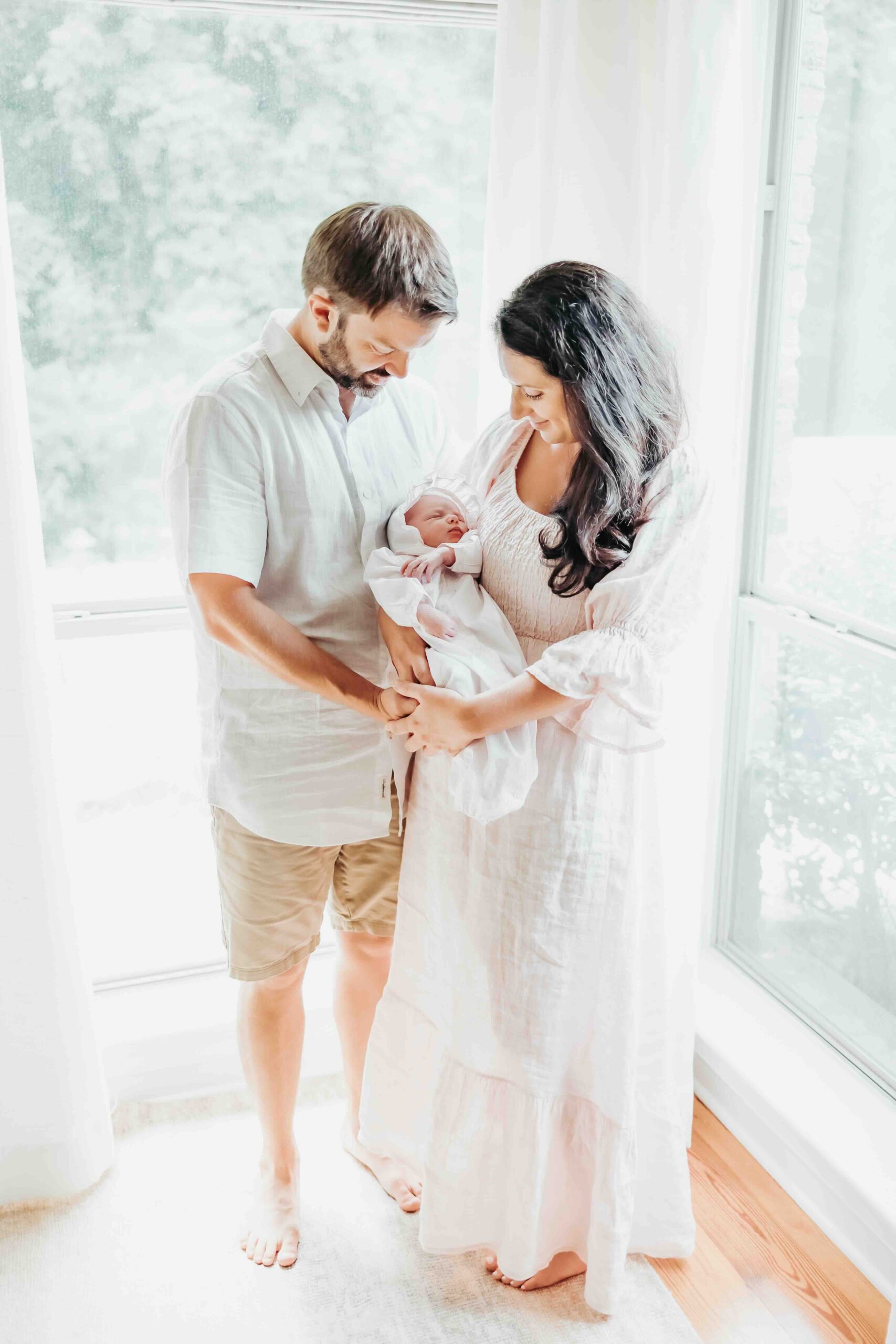 mom and dad gaze at their newborn in covington louisiana