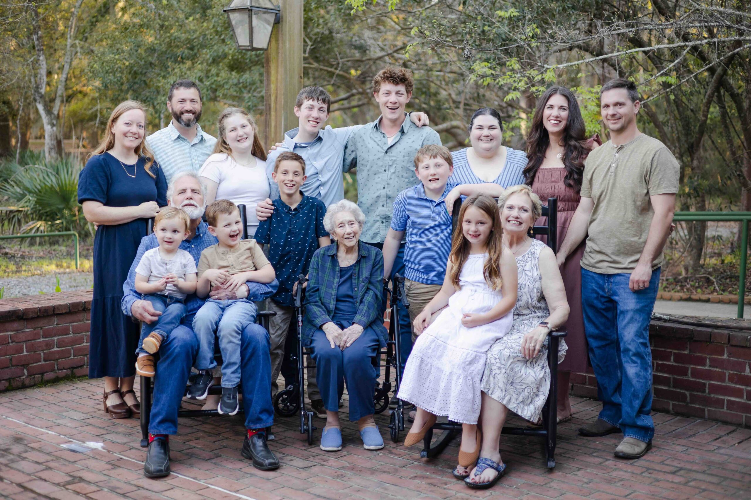 an extended family of sixteen smiles naturally for their family photographer in mandeville louisiana