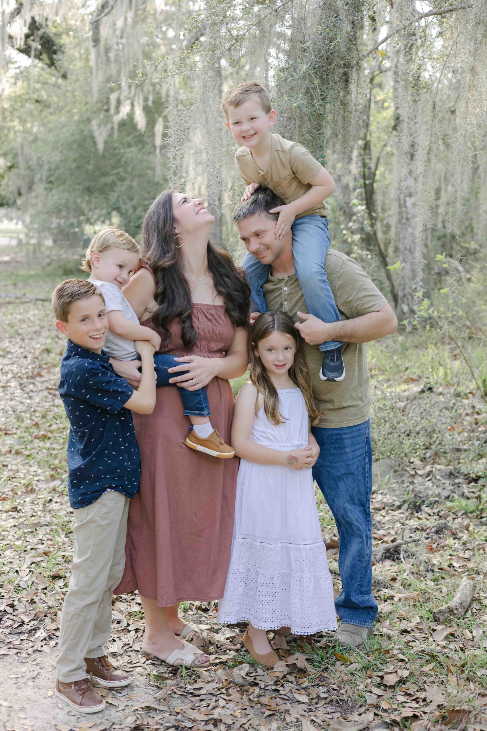 a family of six smiles naturally for their family photographer in mandeville louisiana